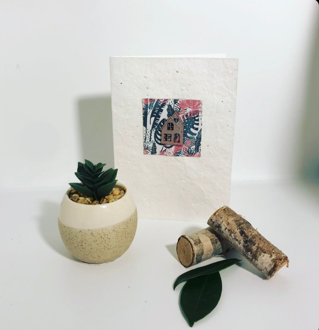 Seeded, plantable greeting card. With hand painted, wooden 'home' motif on embossed background