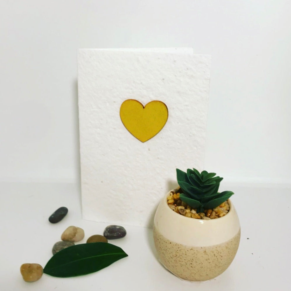 Seeded, plantable greeting card. With hand painted yellow heart motif .