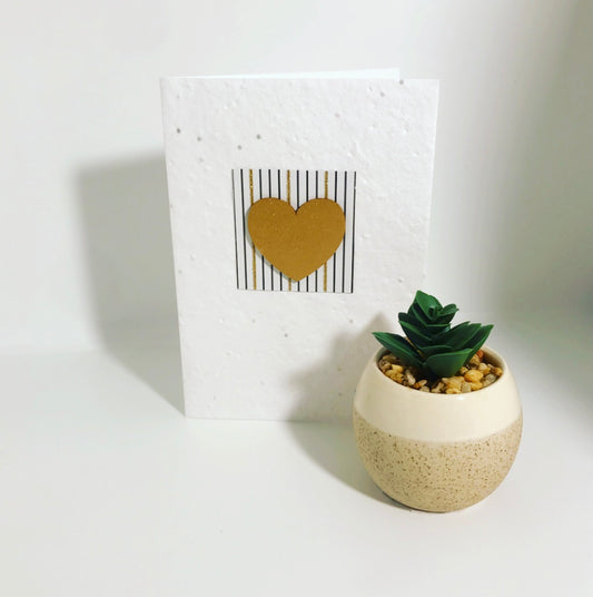 Seeded, plantable greeting card. With hand painted gold heart motif on patterned background..