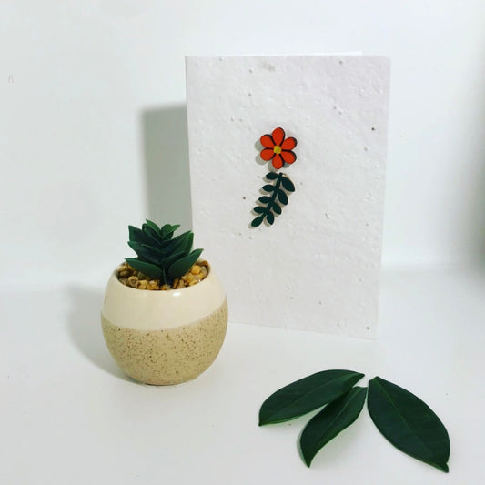 Seeded, plantable greeting card. With hand painted orange and green leaf flower motif .